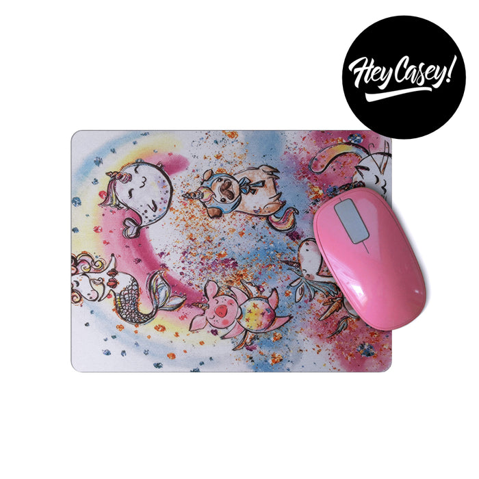 Mouse pad in pink, blue and yellow with cute line drawings of unicorns