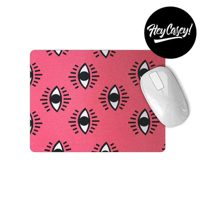 pink mouse pad with black and white eye design
