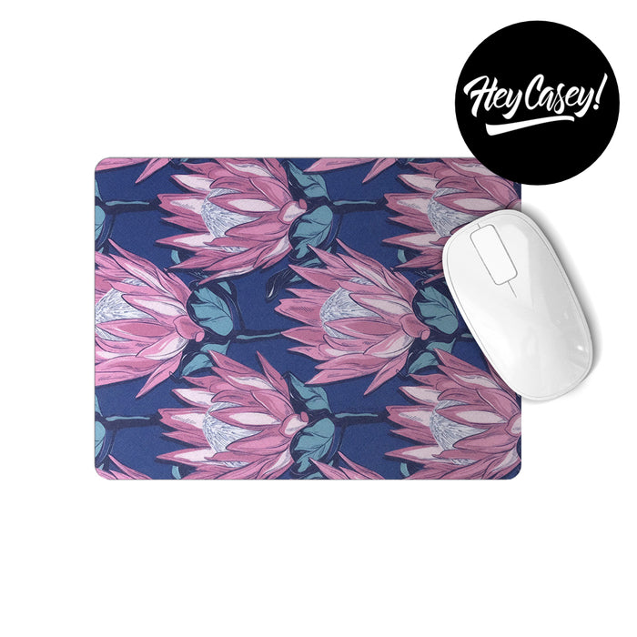 A rectangular mouse pad with a modern king protea print