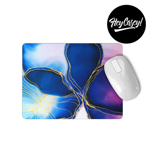 A rectangular mouse pad wtih watercolour wash and gold line drawing